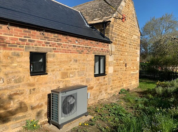 Picture of a heat pump at the back of a house