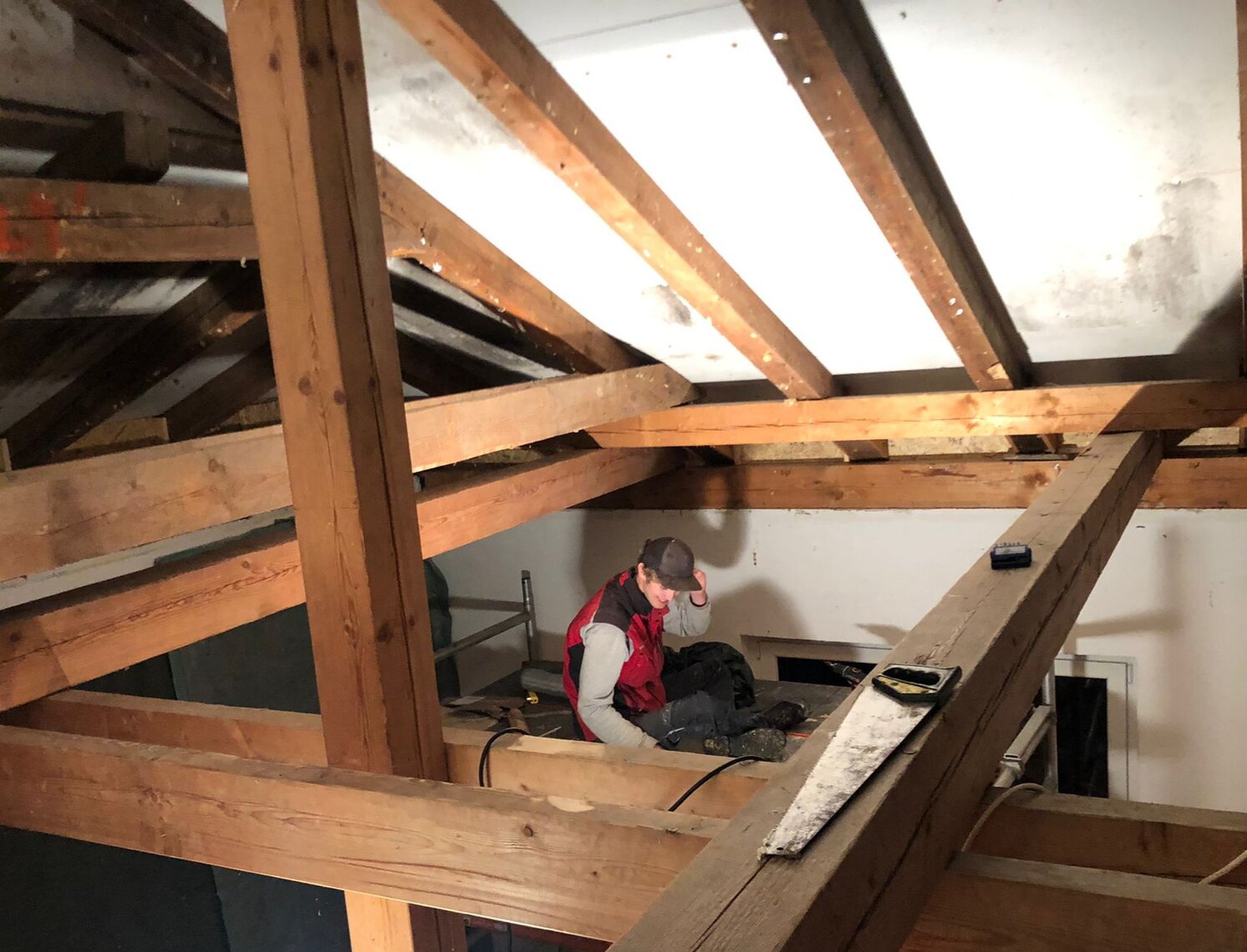 Photo of a person starting to renovate the roof trusses